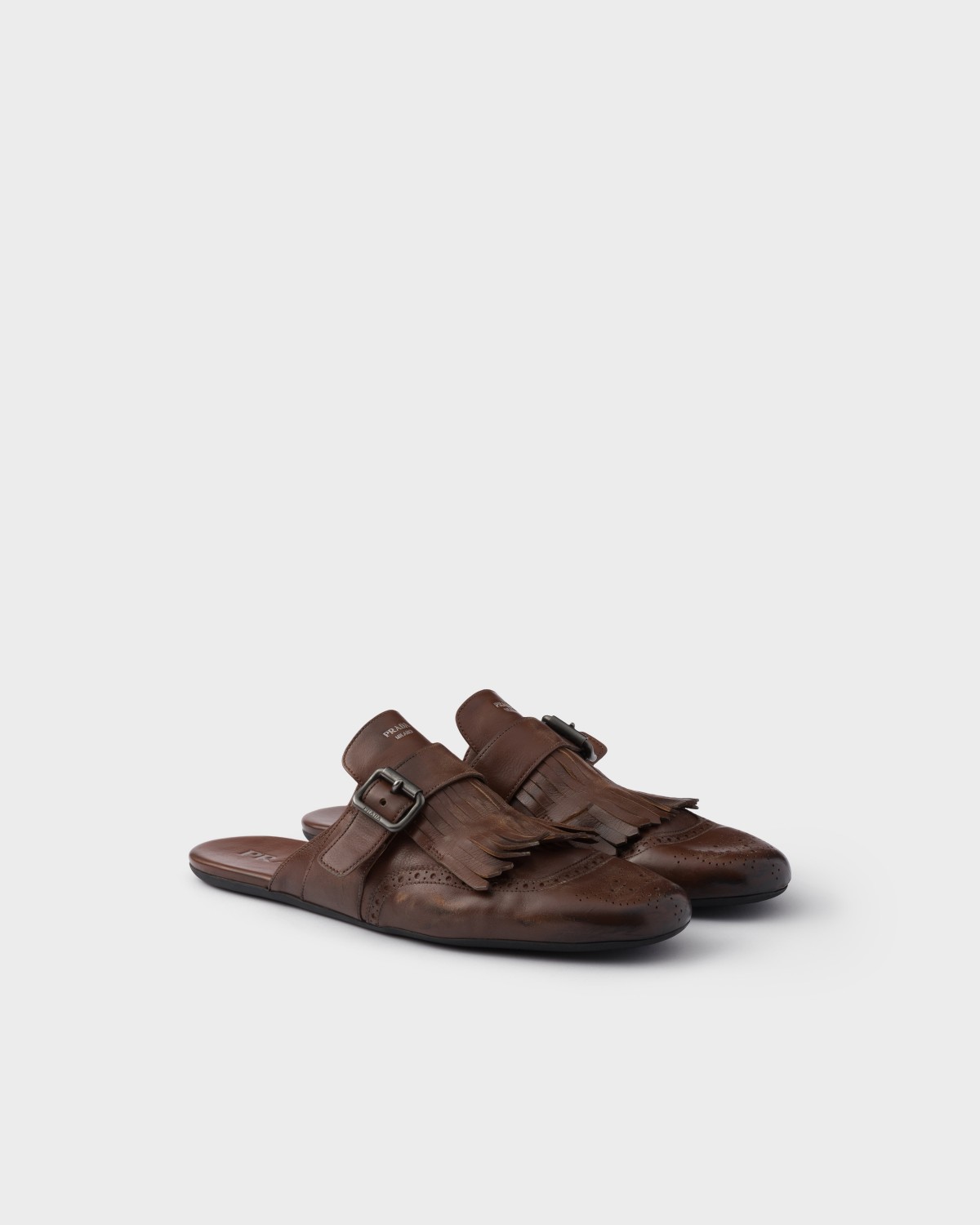 Prada Shuffle Antiqued Leather Mules With Buckled Strap And Fringe Cognac